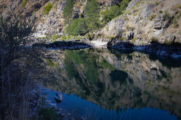 photo of Salmon River above Riggins ID with clear reflection of the canyon walls on the water