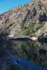 photo of Salmon River above Riggins ID with clear reflection of the canyon walls on the water