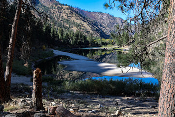 drone photo of Salmon River Canyon upstream from Riggins ID with white sandy beaches and beautiful clear reflection of the canyon walls and blue sky