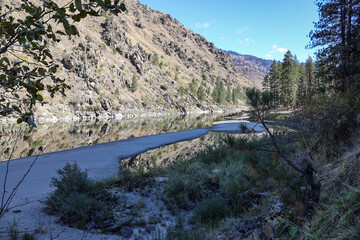 photo of Salmon River above Riggins ID with clear reflection of the canyon walls on the water
