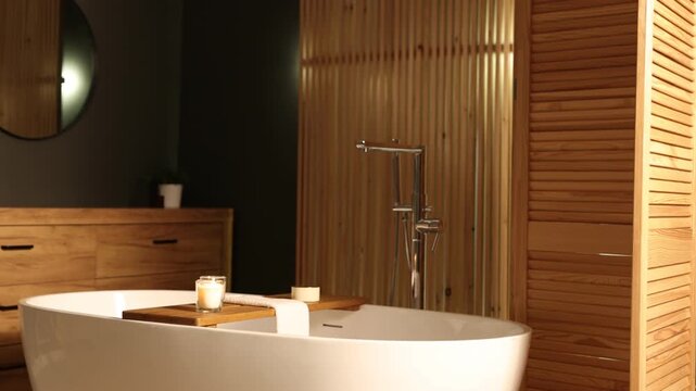 Tub, wooden folding screen and vanity in bathroom, camera moving in. Interior design