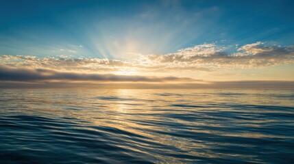 Obraz premium A serene ocean view at sunrise, featuring gentle waves, vibrant skies, and radiant sunlight reflecting on the water's surface.