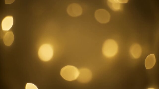 Soft gold bokeh lights drifting slowly in dreamy New Year atmosphere