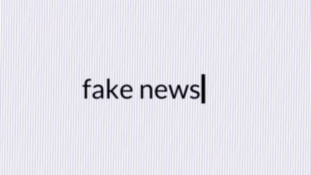 Words &ldquo;fake news&rdquo; being typed on a blank digital screen, representing misinformation, online deception, media distortion, and modern information risks in the digital age 