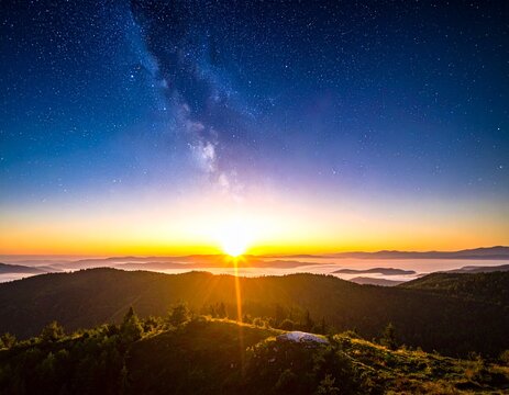 The sun's rays begin to shine through the starry night sky, gradually brightening the sky