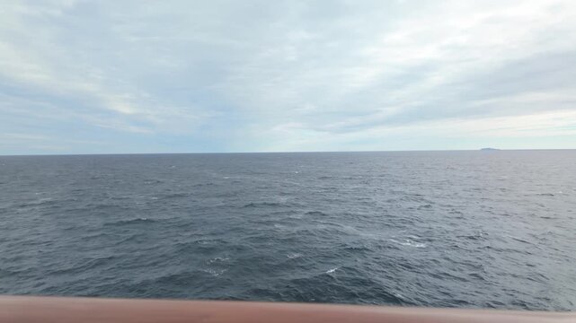 Gimbal panning shot from a moving ship of the balcony view of the open ocean while cruising in the Pacific Northwest. 4K at 30 FPS