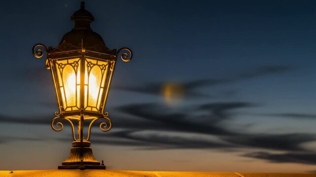 Illuminated vintage street lantern glows against a serene dusk sky creating a warm atmosphere