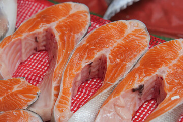 Fresh fish slices on display at market in early morning