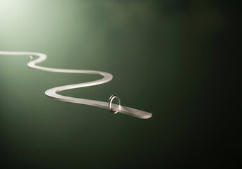 Sleek silver ribbon forming a winding path with a simple ring, symbolizing connection and journey on a deep green backdrop