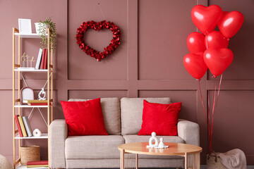 Interior of living room decorated for Valentine's Day with sofa, table and heart-shaped balloons © Pixel-Shot