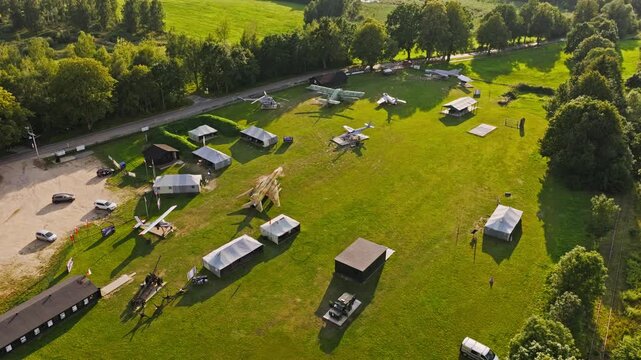 Drone establishing shot of Wilcze Lotnisko museum with aircraft and hangars