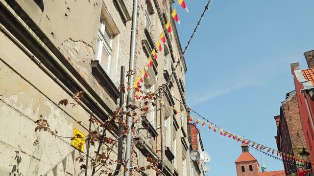 Atmospheric slow motion view showing festive flags in old Polish town