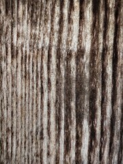 The surface of an old, brown wooden plank.
