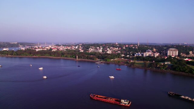 Goa capital city Panaji with Mandovi River, ships and speed boats at india. day time, push back shot, drone shot, 4k.