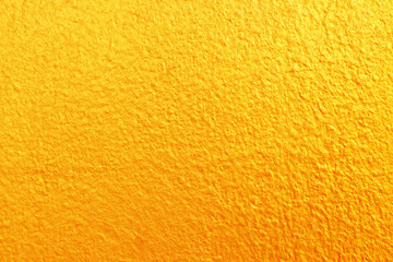 Gold or yellow paint on cement wall texture  background.