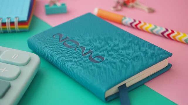 Notebook and stationery are arranged on a colorful table