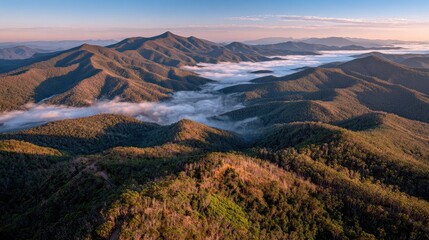 mountain peaks above morning fog, dramatic sunrise sky, wide angle nature photography, no people 