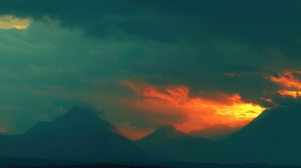 sunrise through clouds over mountain peaks, calm nature scene, no people 