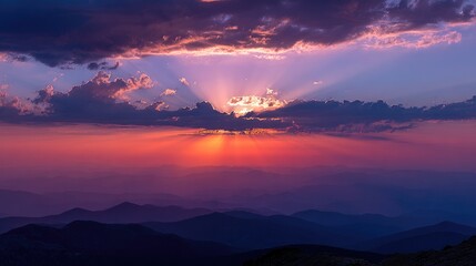 sunrise through clouds over mountain peaks, calm nature scene, no people 