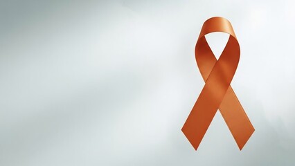 Symbol of awareness: a satin orange ribbon, signifying support and solidarity for various causes, gracefully displayed against a soft gradient background.