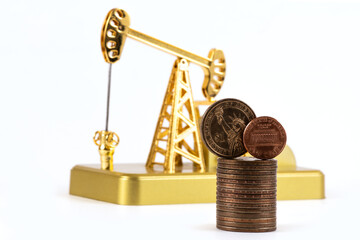 
US $1, US cent and gold oil pump coins on a white background