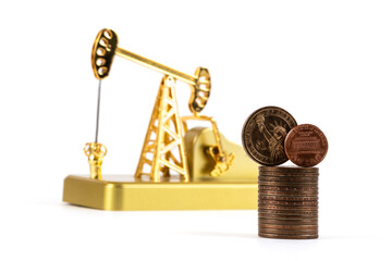 
US $1, US cent and gold oil pump coins on a white background