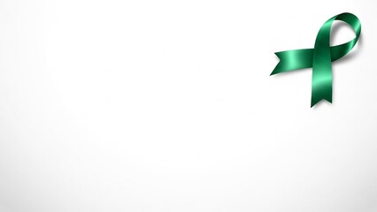 Symbol of hope: a lustrous emerald green awareness ribbon on a clean white background
