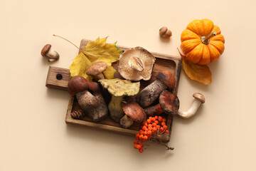 Composition with cutting board with fresh mushrooms on beige background