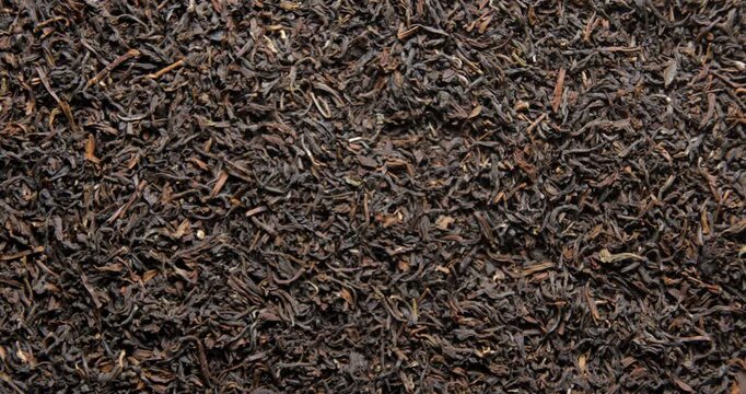 Tea dried leafs close up studio shot over rotating