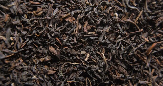 Tea dried leafs close up studio shot over rotating