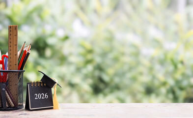 Student creative desktop with colorful stationery and 2026 desk calendar with graduation hat. Copy space for text, Back to school, Education concept