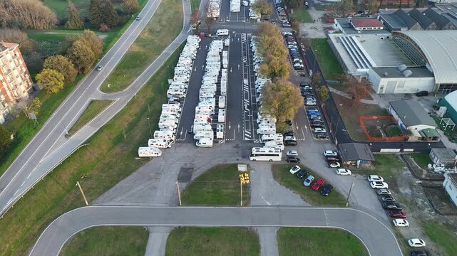 200-space motorhome hub, highlighting the city's seasonal management of "pleinair" tourism and its integrated shuttle links to the historic core in Lombardy, Italy