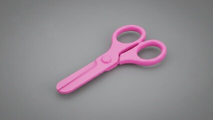 Pink plastic safety scissors with blunt tips, designed for children's crafting and school activities, presented on a neutral grey background.