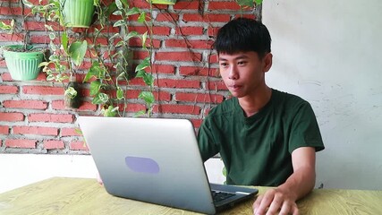 Asian teenager engaging through a webcam, ideal for e-learning platforms, social media connectivity ads, remote family communication features, and youth-led digital business campaigns