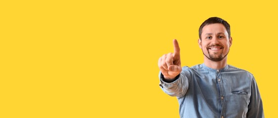 Happy man using virtual screen on yellow background. Banner for design