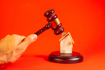 wooden gavel in hand of judge on orange background. law concept