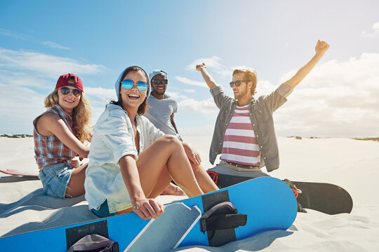 Freedom, hobby and sand board with friends outdoor on dunes for adventure activity or extreme sports. Celebration, travel and vacation with group of sandboarding people in nature for holiday or trip