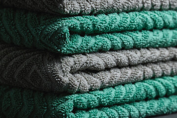 Close-up of Folded Teal and Grey Textured Cotton Bath Towels