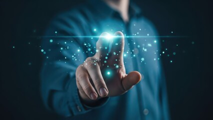 man in blue shirt touching glowing particles with finger