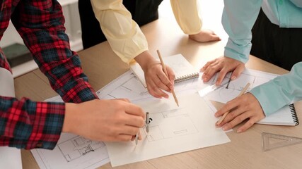 Video of architects or smart engineers use measurement tool, divider and pencil hand writing detail on blueprint for construction accuracy at architectural office. Focus on hand. Closeup. Delineation.