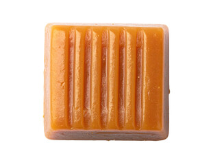 A single, square-shaped caramel candy with vertical groove details