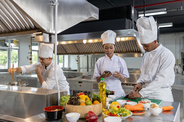 Professional chef preparing fresh ingredients in commercial kitchen, representing culinary expertise, food preparation, hygiene standards, restaurant workflow, professional cooking environment.