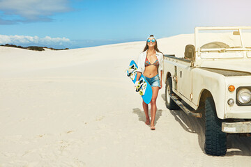 Road trip, sand board and walking with woman outdoor for adventure, extreme sports or hobby. Adrenaline junkie, car and space with person in nature for holiday activity, sandboarding or vacation © peopleimages.com