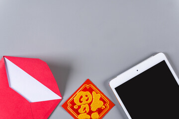 Lunar New Year Celebration with Digital Device and Traditional Decor