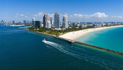 Luxury yacht cruising near Miami skyline. Aerial view of boats on turquoise waters in Miami. Yacht retreat in South Florida Miami. Miami cityscape with sailing vessels. Waterfront Miamis panorama.