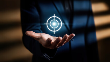 Businessman holding hand with glowing target symbol on palm in dark room with blurred background