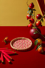 A Lunar New Year scene with fruits, firecracker elements, and decorative patterns. Advertising photo with modern commercial design needs. Concept of Chines new year