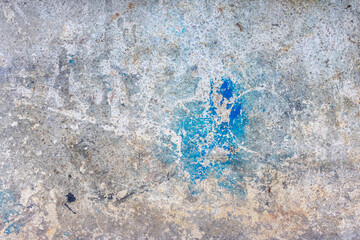 Vintage concrete background accented with blue paint