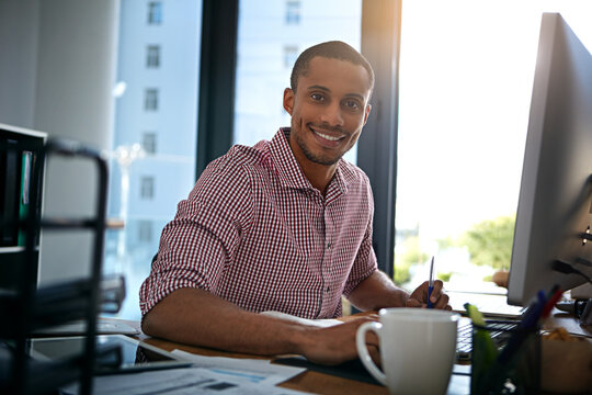 Media agency, portrait and happy man in office, computer and smile with deadline for creative project. Person, copywriting or journalist in workplace, pc or confidence with website blog or submission