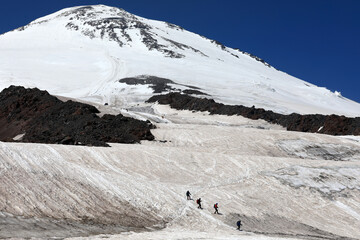 Group Mountaineers Climbing Snowy Slopes